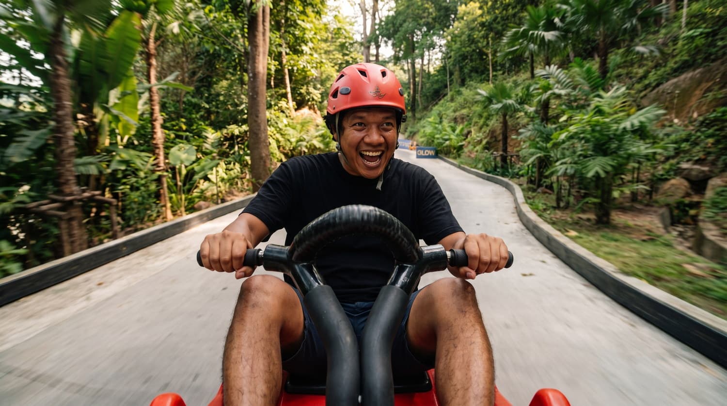 A smiling rider enjoying the jungle luge track