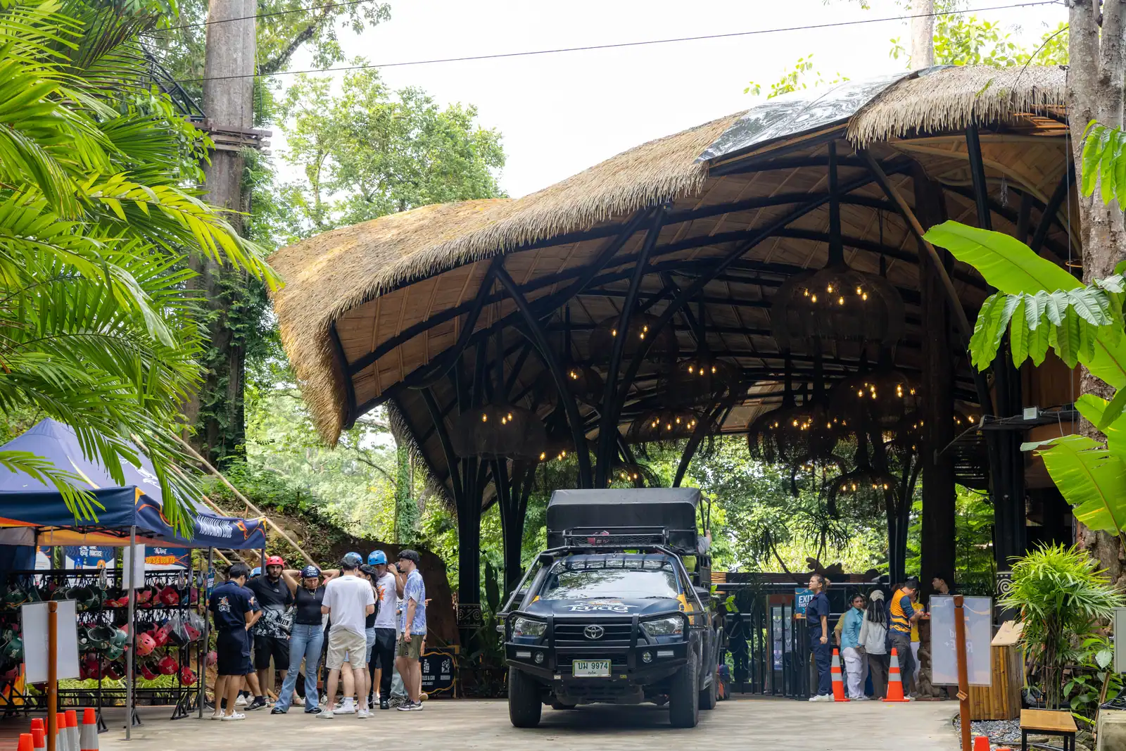 The open-sided Hanuman Luge arrival pavilion with helmet racks and visitors.