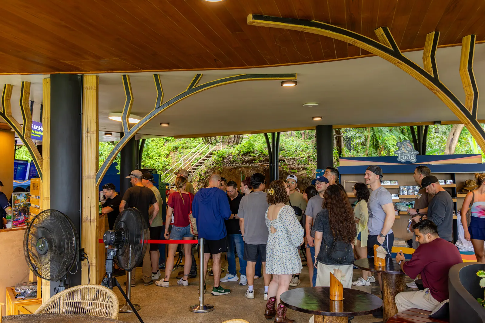 Visitors at the covered Hanuman Luge reception area during daylight.